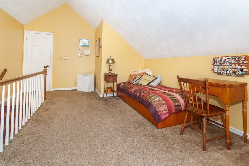 3 Potter Pond, Unit 3 Lexington, MA 02421 - Photo 16 of 20 a bedroom with a bed and chair