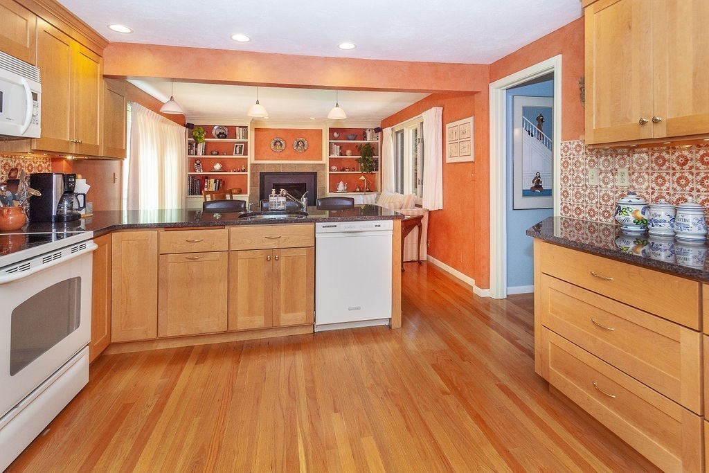 3 Potter Pond, Unit 3 Lexington, MA 02421 - Photo 3 of 20 a kitchen with stainless steel appliances granite countertop wooden floors and granite counter tops