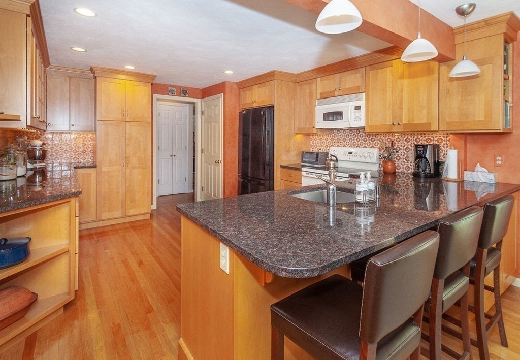 3 Potter Pond, Unit 3 Lexington, MA 02421 - Photo 4 of 20 a kitchen with counter top space cabinets and stainless steel appliances