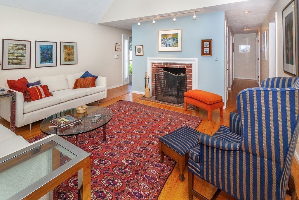 3 Potter Pond, Unit 3 Lexington, MA 02421 - Photo 8 of 20 a living room with furniture fireplace and a wooden floor