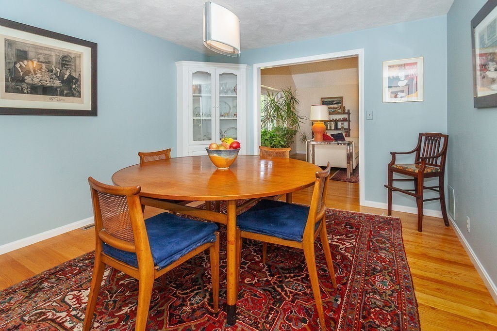 3 Potter Pond, Unit 3 Lexington, MA 02421 - Photo 9 of 20 a view of a dining room with furniture and wooden floor