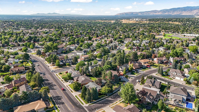 8965 Quail Run Drive Sandy, UT 84093 - Photo 13 of 56 Aerial perspective of suburban area with mountains
