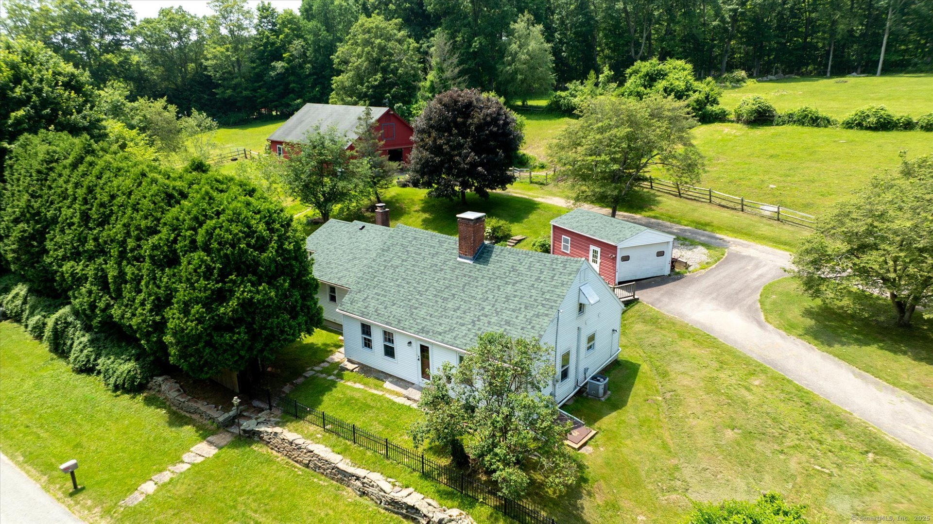 an aerial view of a house with a yard basket ball court and outdoor seating