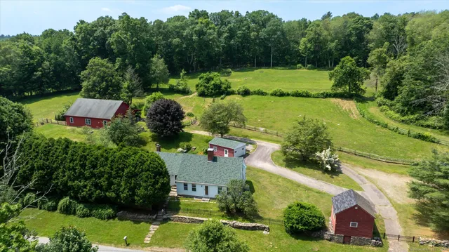 an aerial view of a house with yard swimming pool and outdoor seating