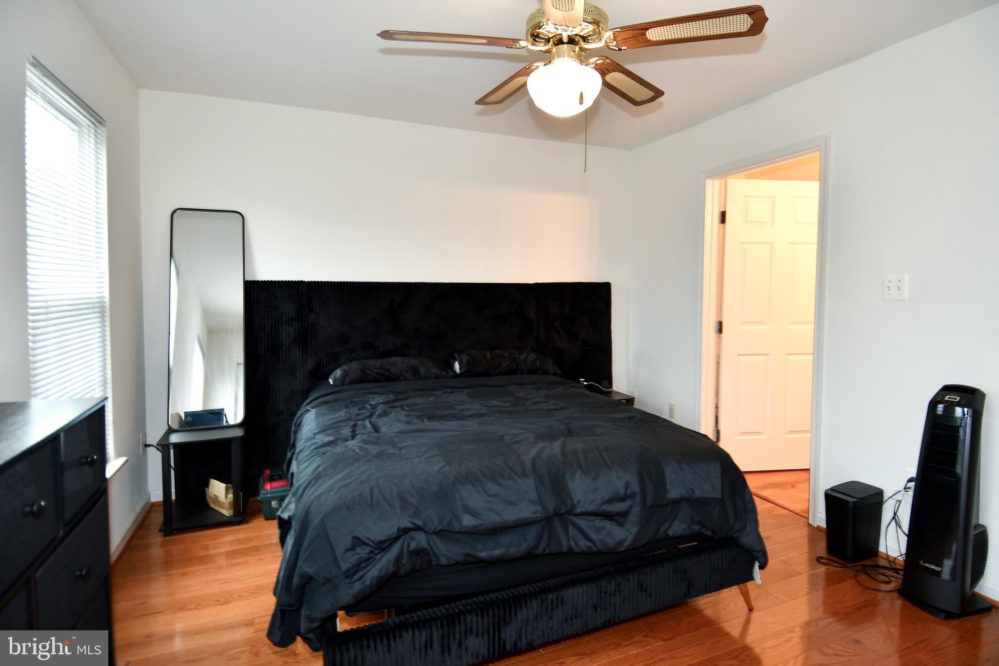 6410 Andrew Matthew Terrace Springfield, VA 22150 - Photo 16 of 31 a bedroom with a bed and a flat tv screen on the dresser