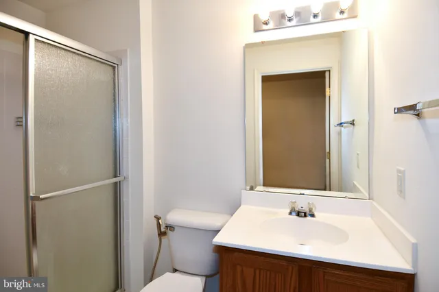 a bathroom with a glass shower door