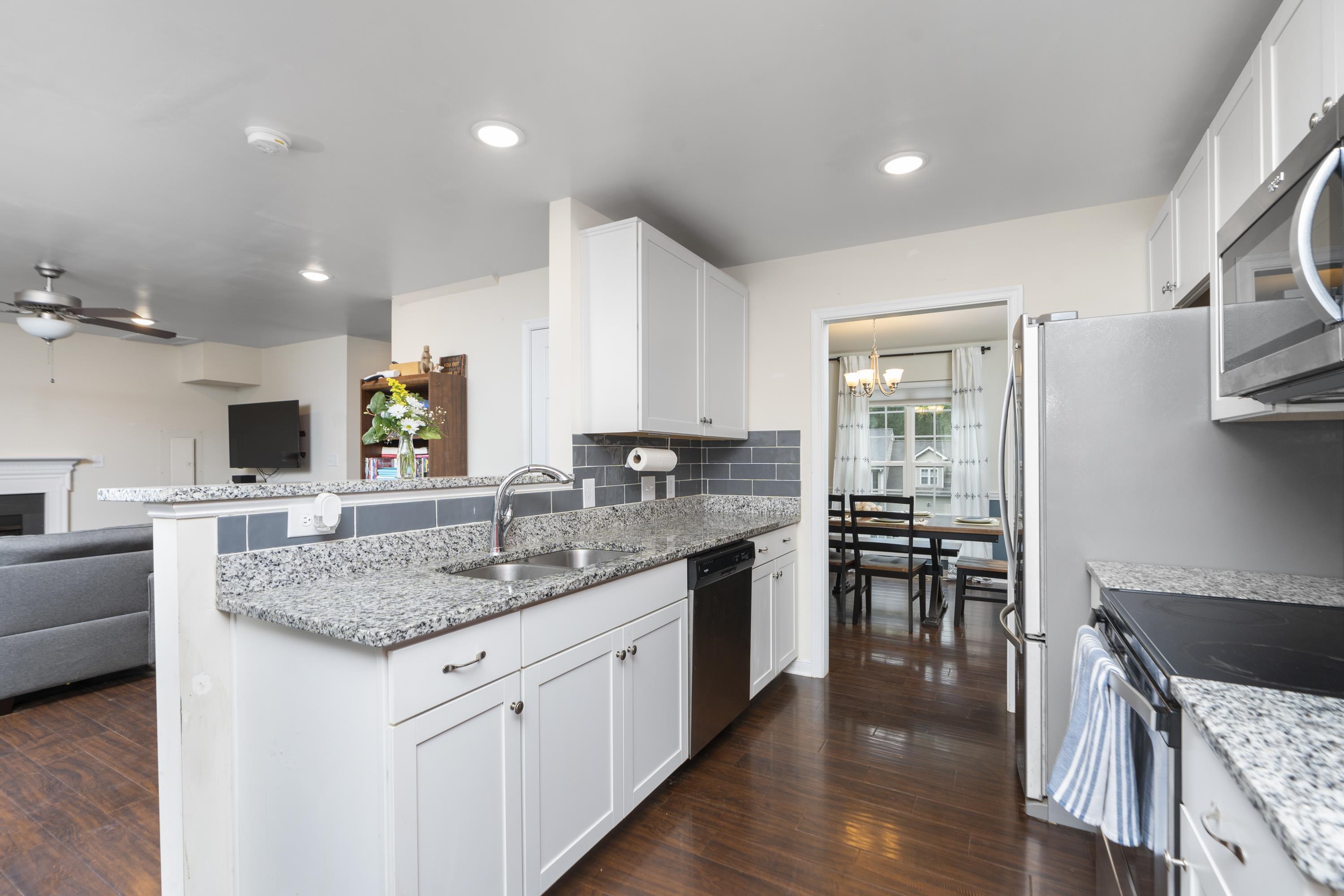 10 Zephyr Road Palmyra, VA 22963 - Photo 19 of 72 a kitchen with stainless steel appliances granite countertop a sink a stove and a wooden floors
