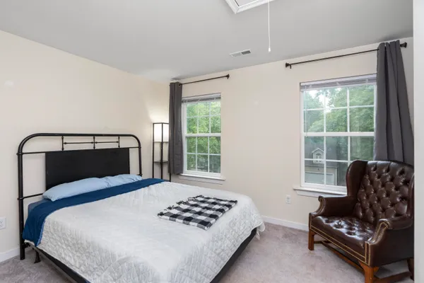 a front view of a residential houses with yard and green space