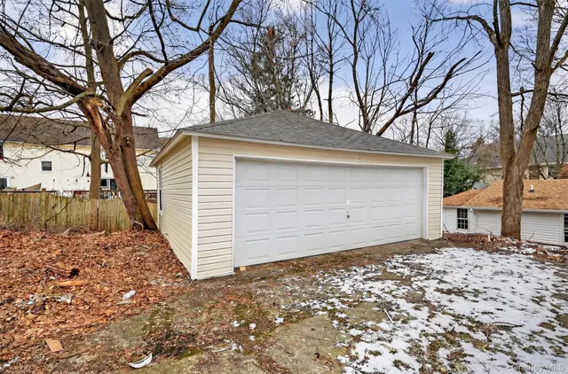 a small white house with a large tree in front of it