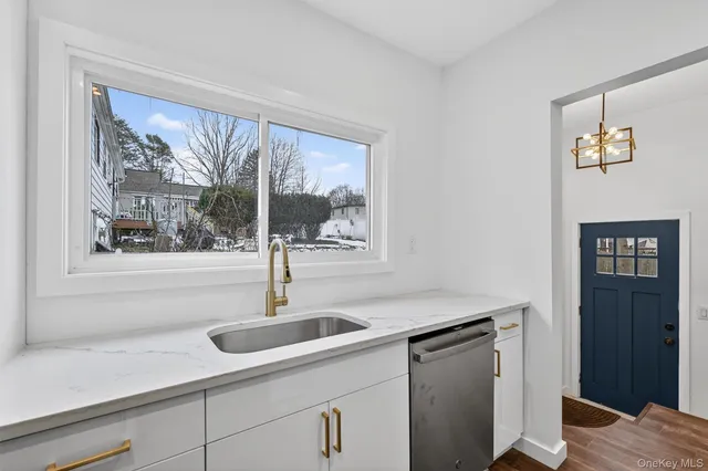 a kitchen with a sink and large window