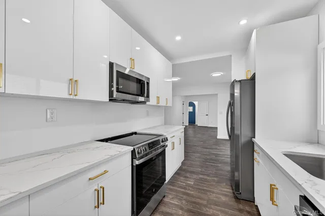 a kitchen with a sink a stove and refrigerator