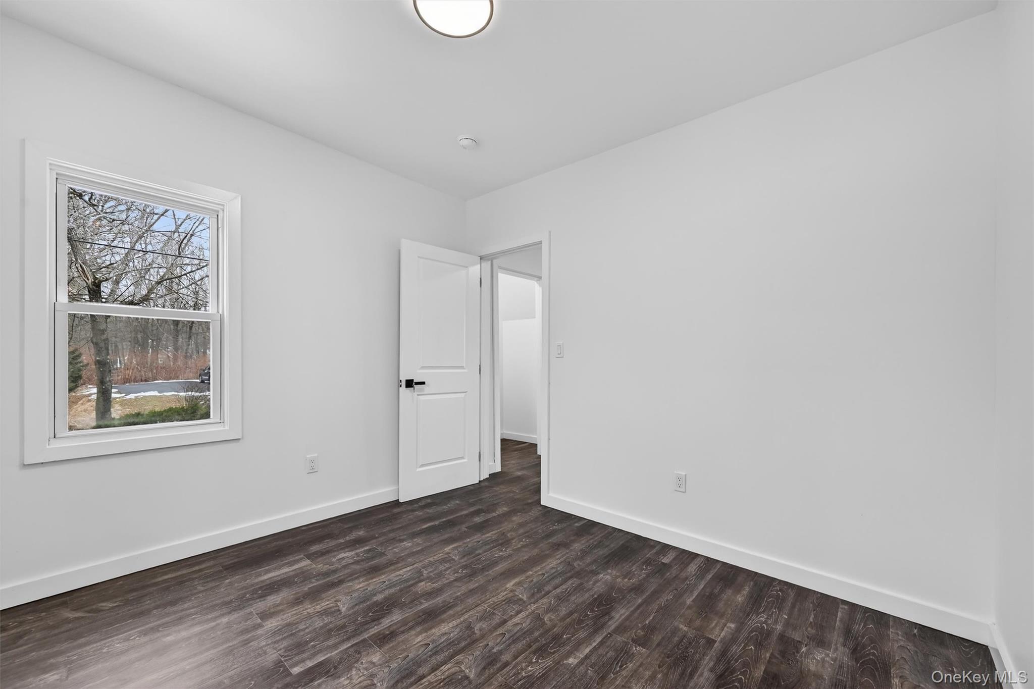 60 Jeanibo Road Monroe, NY 10950 - Photo 9 of 17 a view of an empty room with wooden floor and a window