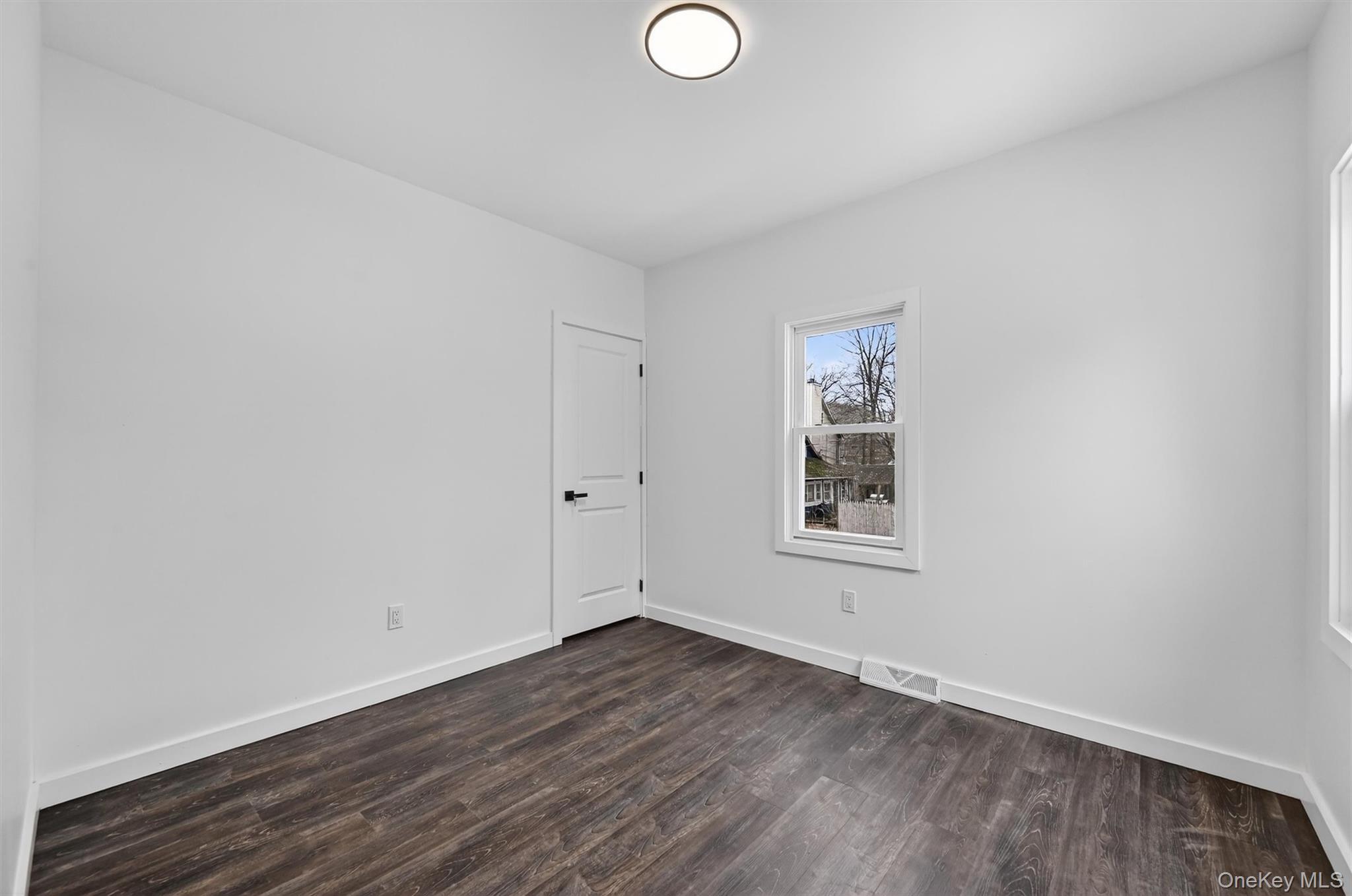 60 Jeanibo Road Monroe, NY 10950 - Photo 10 of 17 an empty room with wooden floor and windows