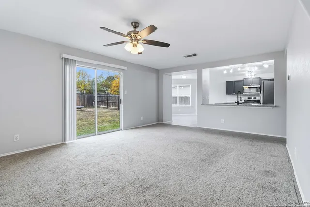 a view of a kitchen with kitchen island a sink wooden floor and counter top space