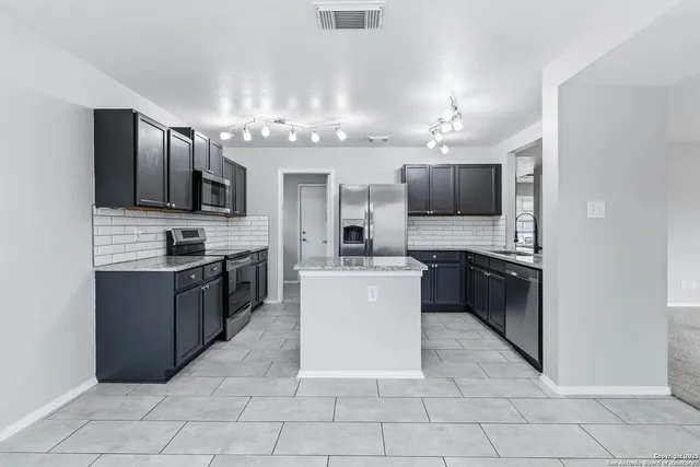 a kitchen with a sink and cabinets
