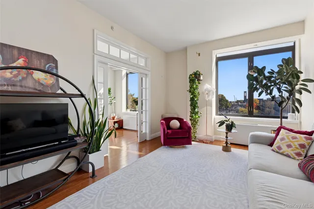 a living room with furniture a fireplace and a potted plant