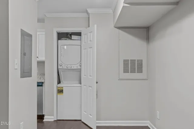 a view of a hallway with wooden floor and a bathroom