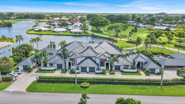 an aerial view of a house with a garden and lake view