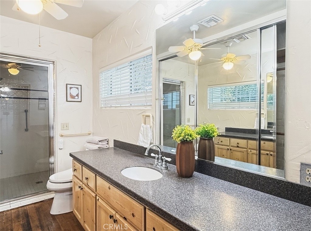 1932 South Barona Road Palm Springs, CA 92264 - Photo 17 of 19 a bathroom with a granite countertop sink a large mirror and a shower