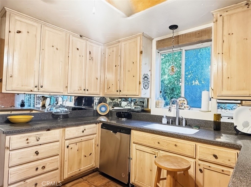 1932 South Barona Road Palm Springs, CA 92264 - Photo 6 of 19 a kitchen with granite countertop white cabinets white appliances and sink