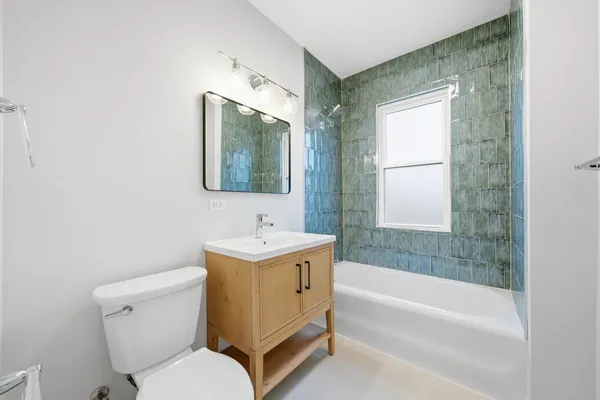 an empty room with windows and fireplace