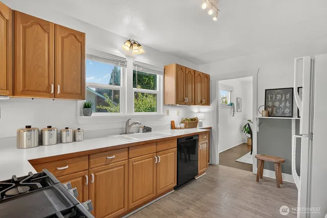 a view of a hallway with front door wooden floor and windows