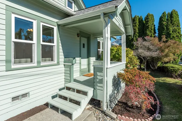 a view of a hallway with wooden floor and a potted plant