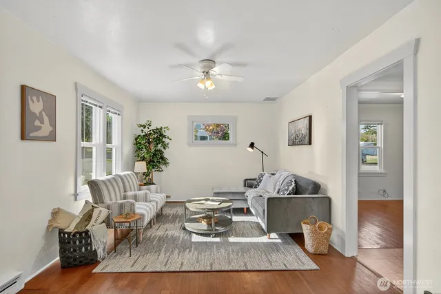 a living room with furniture and wooden floor