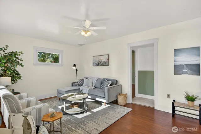 a living room with furniture and a wooden floor