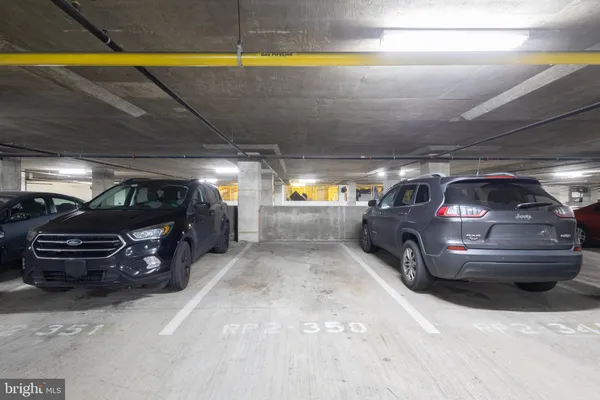 a view of parking garage with cars parked