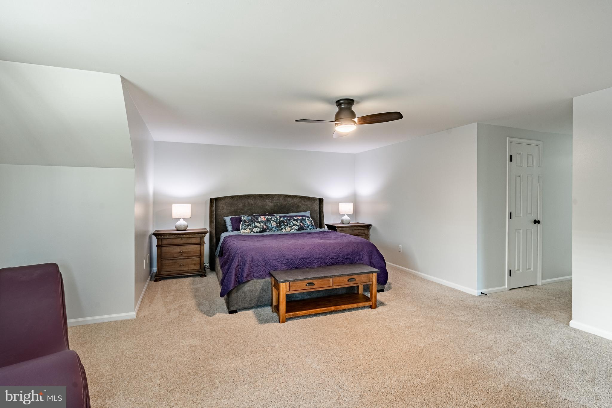 116 Hartman Road Pottstown, PA 19465 - Photo 23 of 49 a spacious bedroom with a bed and a chandelier