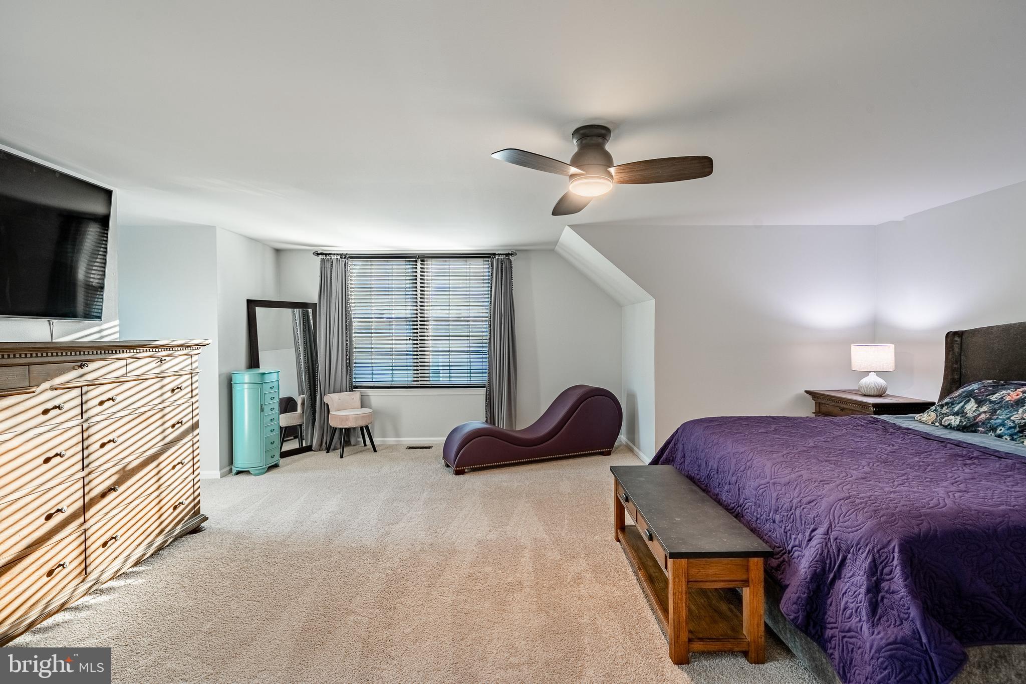116 Hartman Road Pottstown, PA 19465 - Photo 24 of 49 a spacious bedroom with a bed a chandelier and a couch