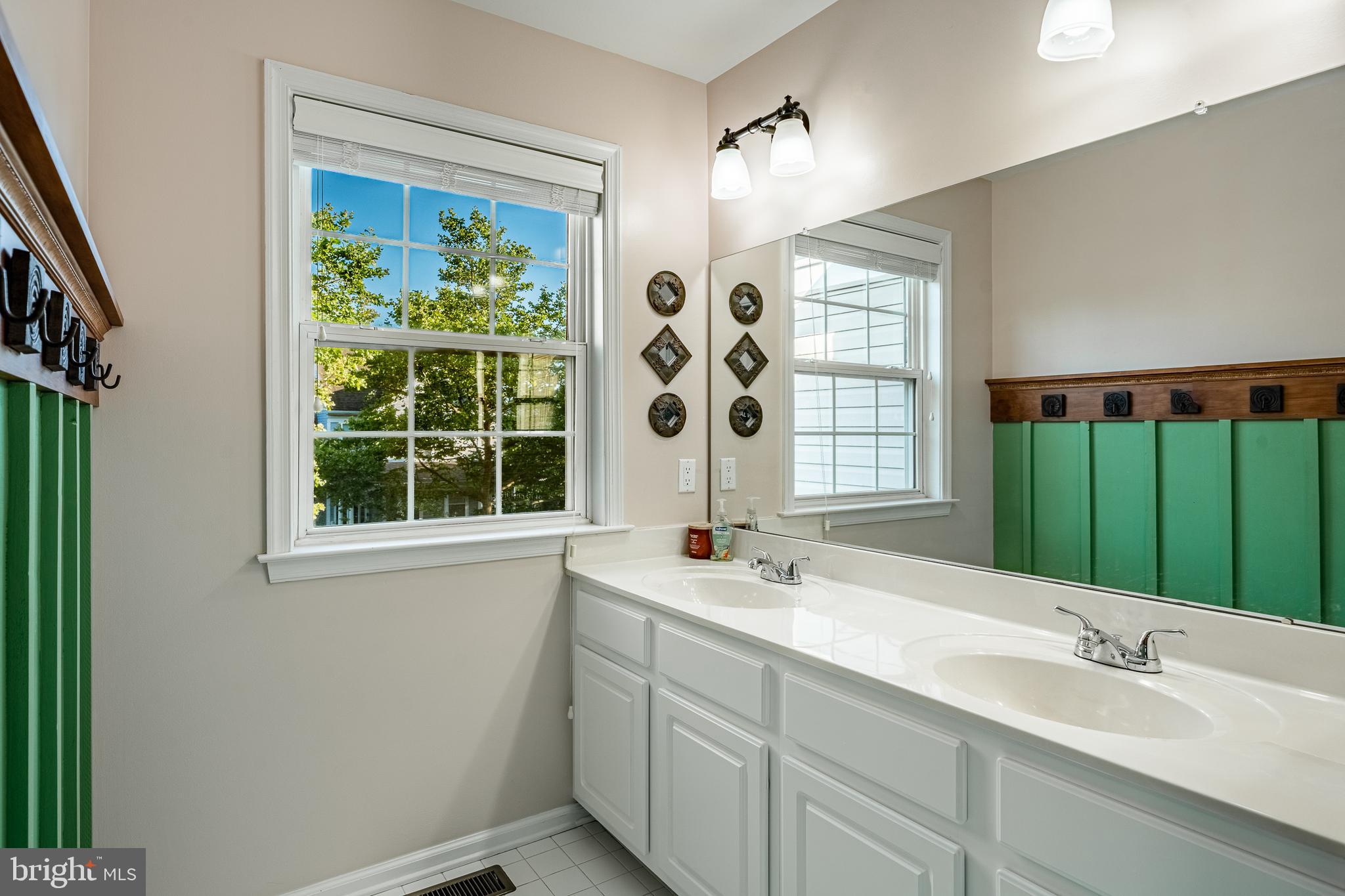 116 Hartman Road Pottstown, PA 19465 - Photo 32 of 49 a bathroom with a double vanity sink a mirror and a bathtub