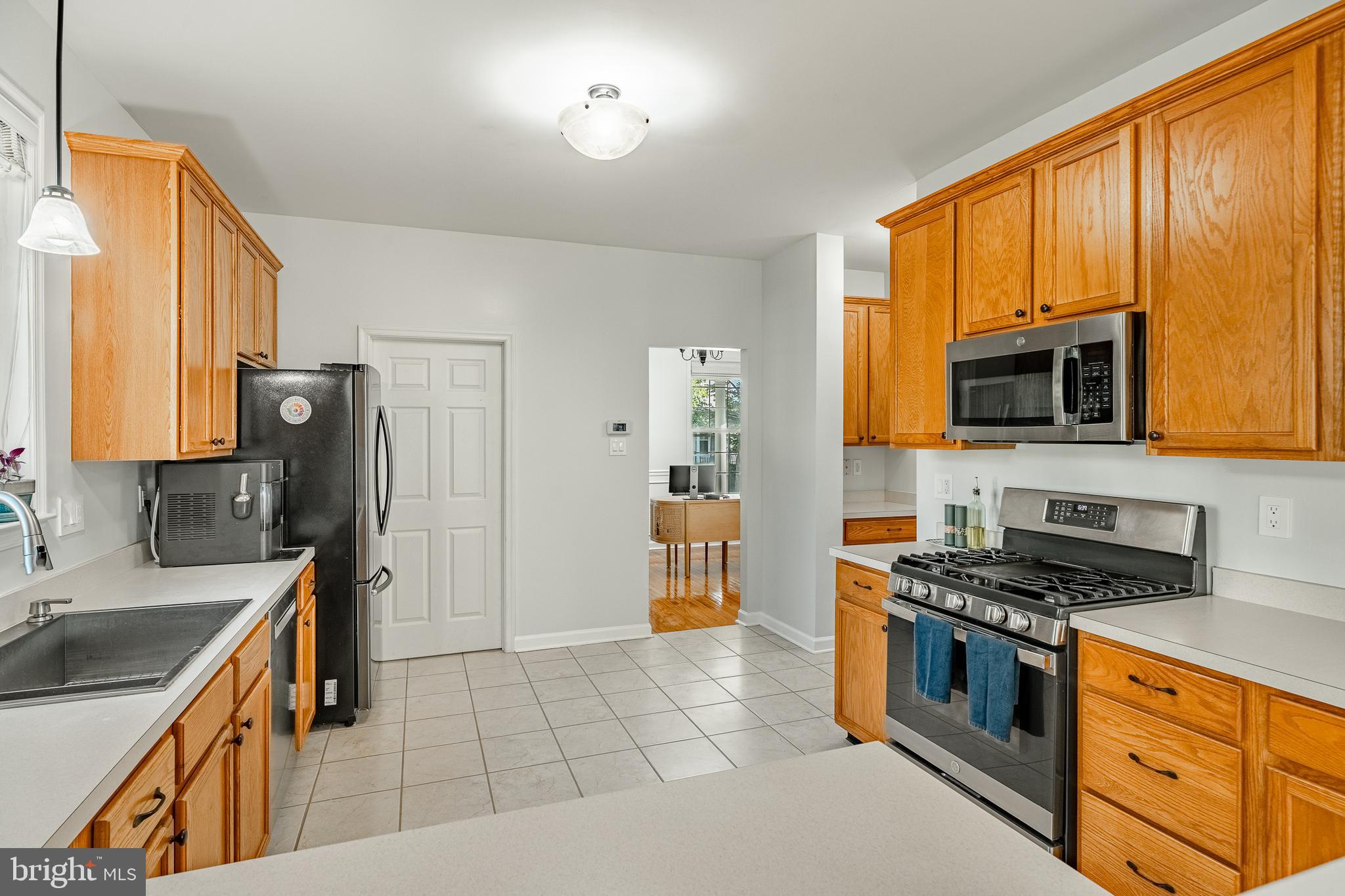 116 Hartman Road Pottstown, PA 19465 - Photo 9 of 49 a kitchen with stainless steel appliances a stove sink and microwave