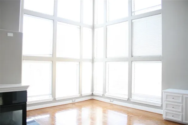 wooden floor in an empty room with a fireplace