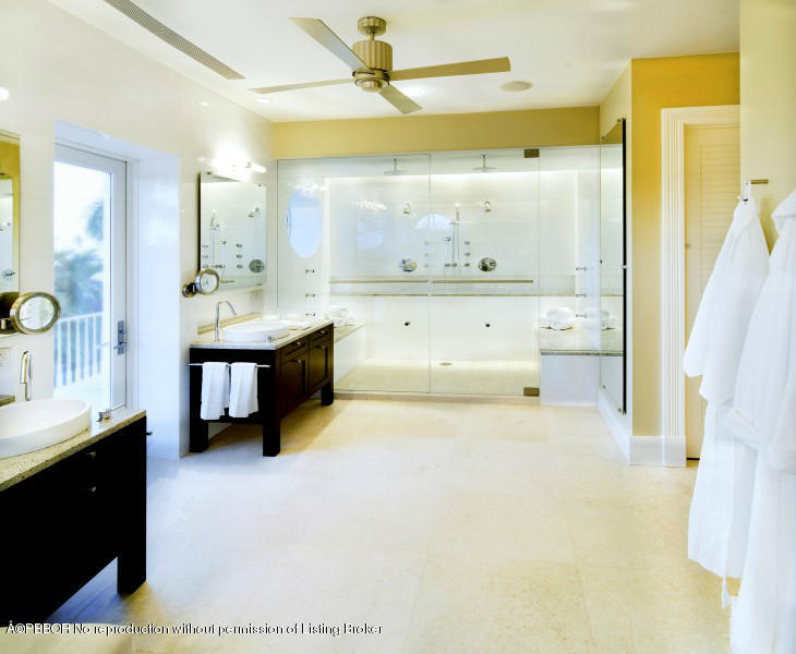 85 Curlew Road Manalapan, FL 33462 - Photo 17 of 30 a spacious bathroom with a double vanity sink a mirror and a shower