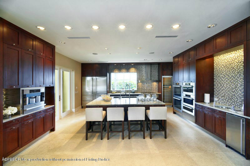 85 Curlew Road Manalapan, FL 33462 - Photo 10 of 30 a kitchen with stainless steel appliances granite countertop table chairs sink and cabinets