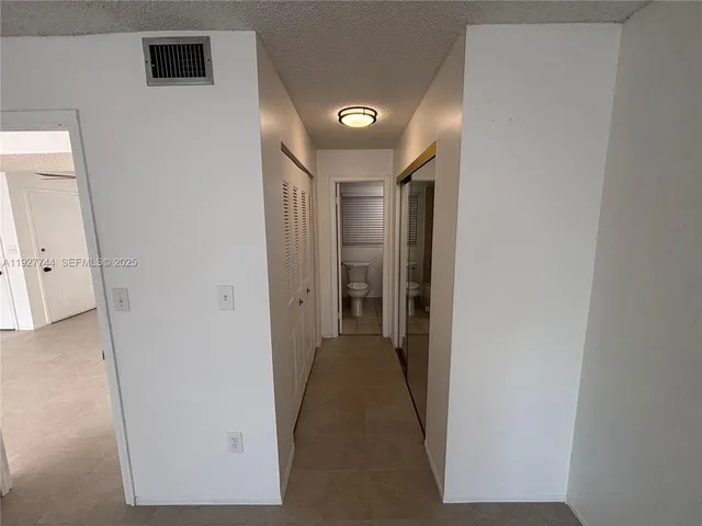 a bathroom with a sink a toilet a mirror and vanity