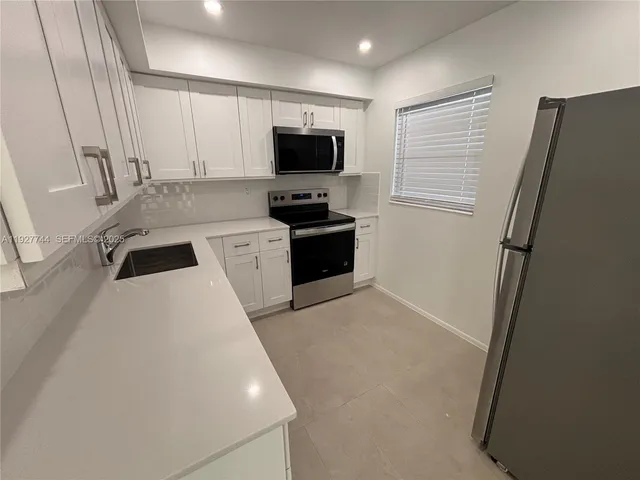 a kitchen with a refrigerator stove and microwave