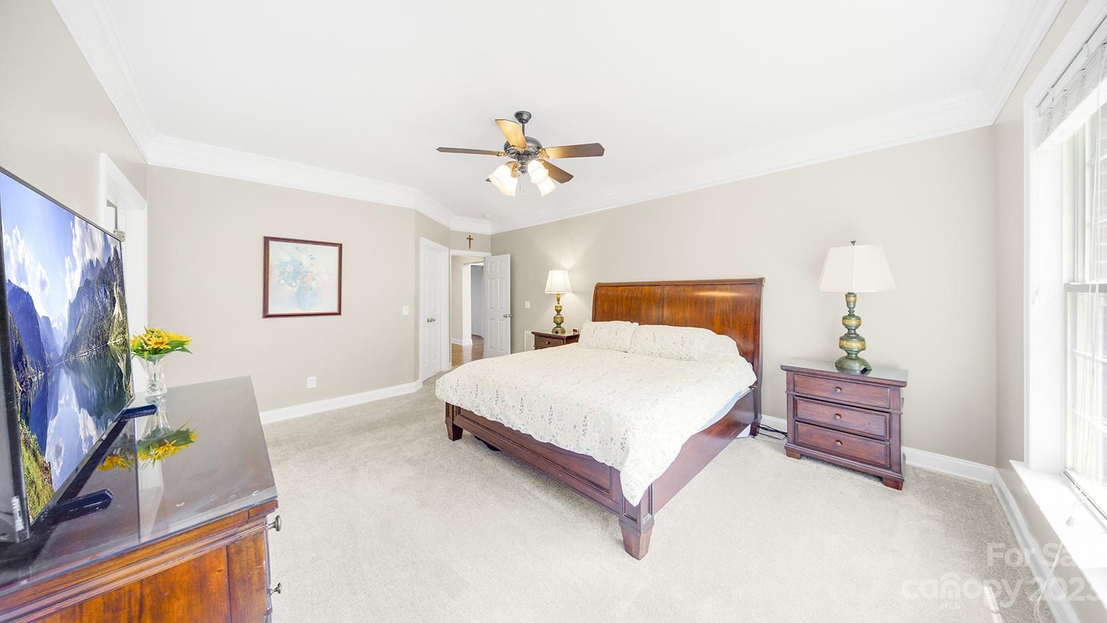 2512 Cornwall Court Northwest Concord, NC 28027 - Photo 19 of 48 a bedroom with a bed and a chandelier