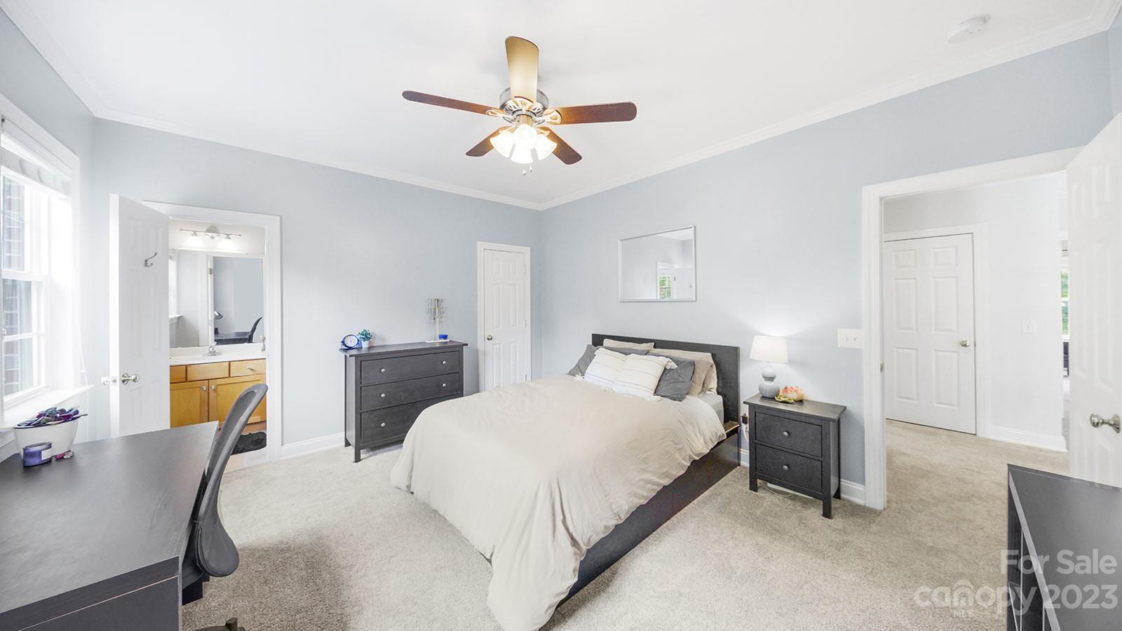 2512 Cornwall Court Northwest Concord, NC 28027 - Photo 28 of 48 a bedroom with a bed and a chandelier