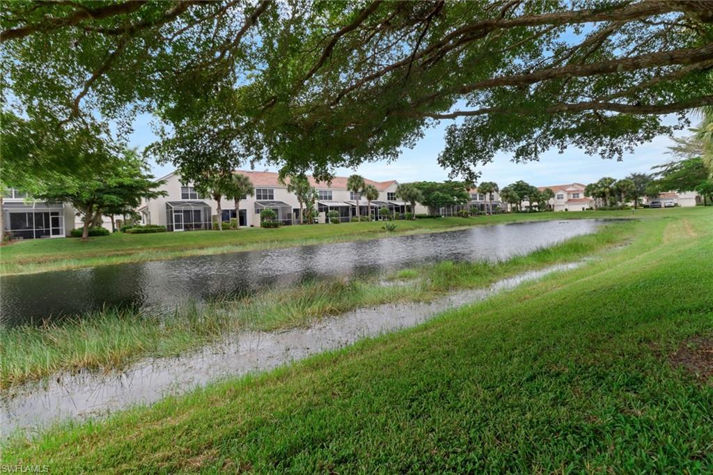 815 Hampton Circle, Unit 143 Naples, FL 34105 - Photo 17 of 30 a view of a lake with houses