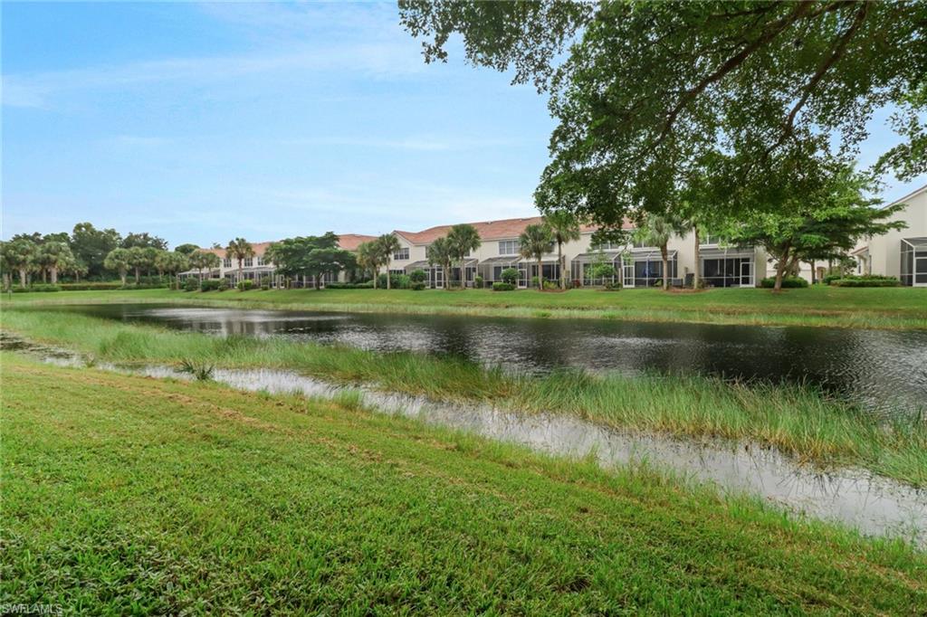 815 Hampton Circle, Unit 143 Naples, FL 34105 - Photo 18 of 30 a view of a lake with houses in the back