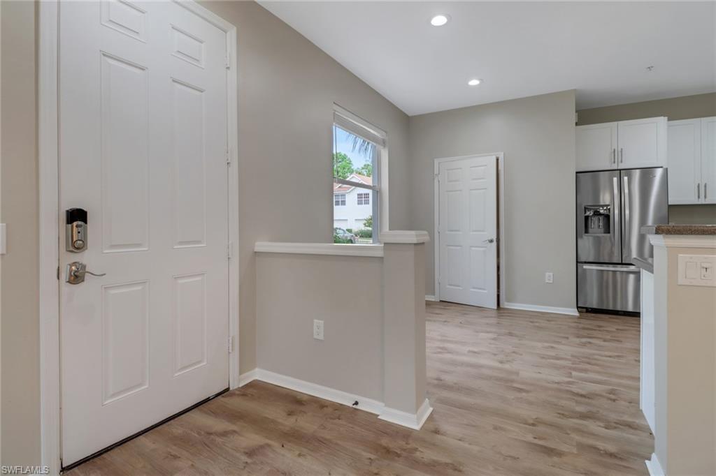 815 Hampton Circle, Unit 143 Naples, FL 34105 - Photo 2 of 30 a view of a kitchen with a refrigerator a microwave and a sink