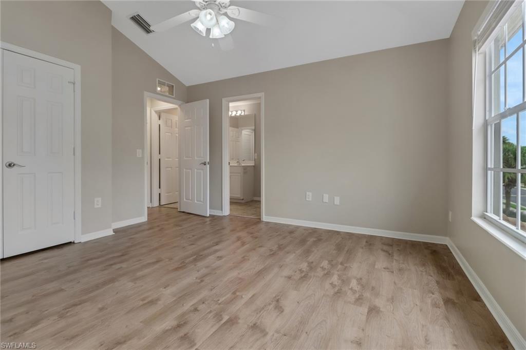 815 Hampton Circle, Unit 143 Naples, FL 34105 - Photo 26 of 30 wooden floor in an empty room with a window