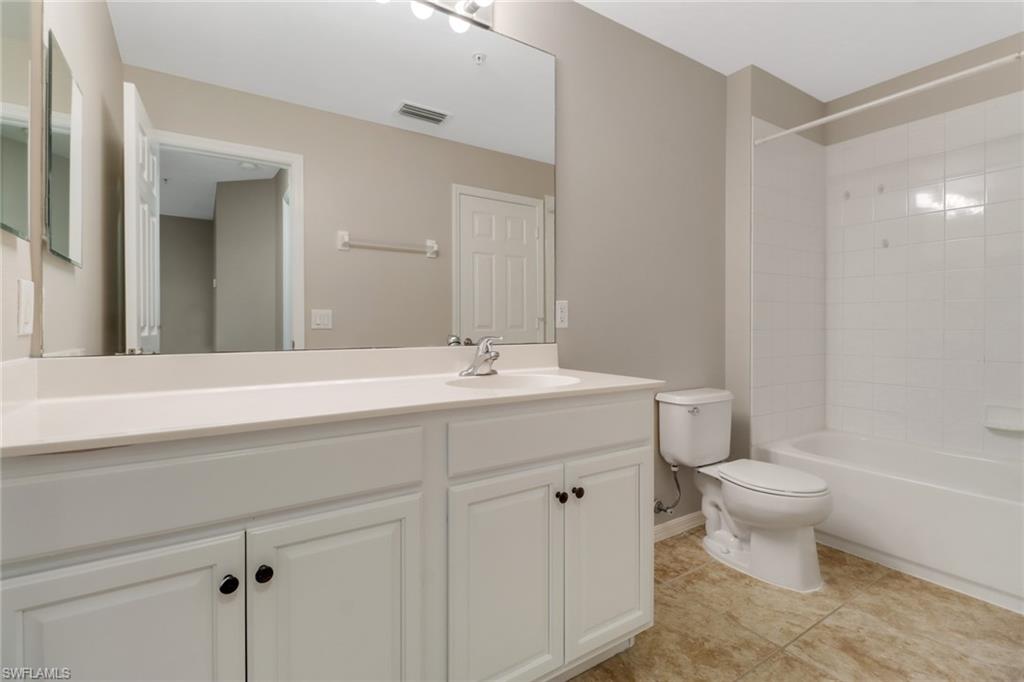 815 Hampton Circle, Unit 143 Naples, FL 34105 - Photo 27 of 30 a bathroom with a sink toilet and a mirror