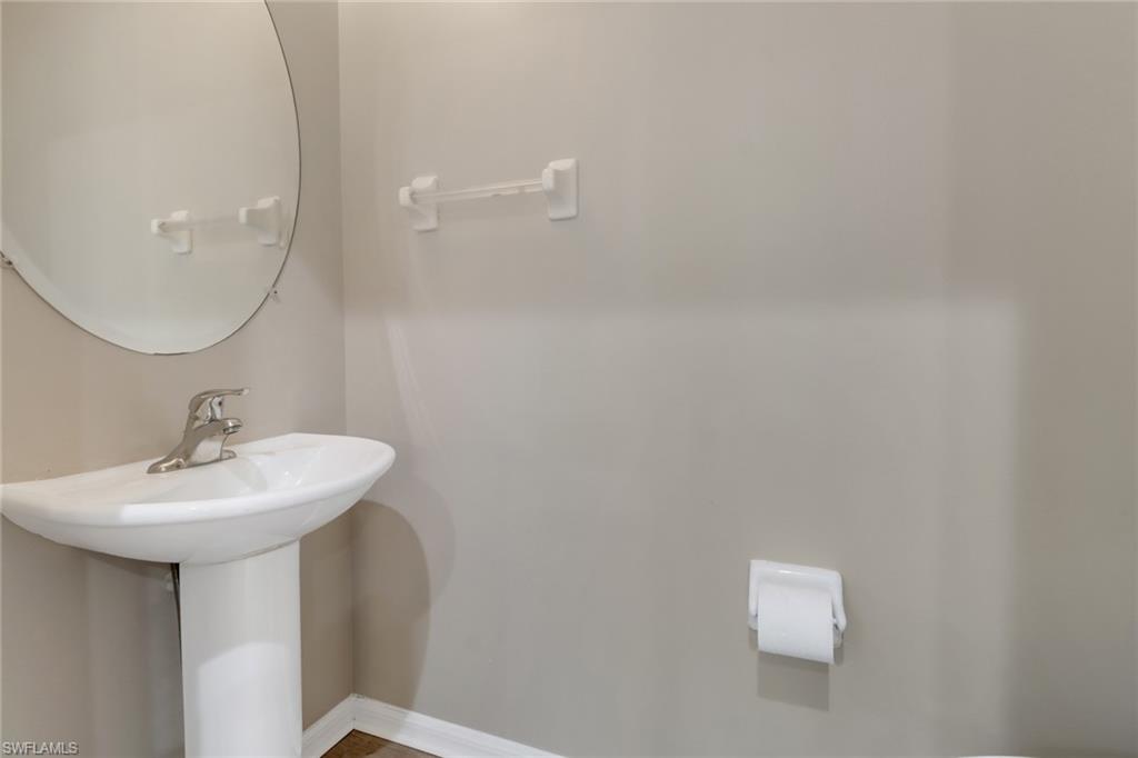 815 Hampton Circle, Unit 143 Naples, FL 34105 - Photo 8 of 30 a bathroom with a sink a mirror and a shower