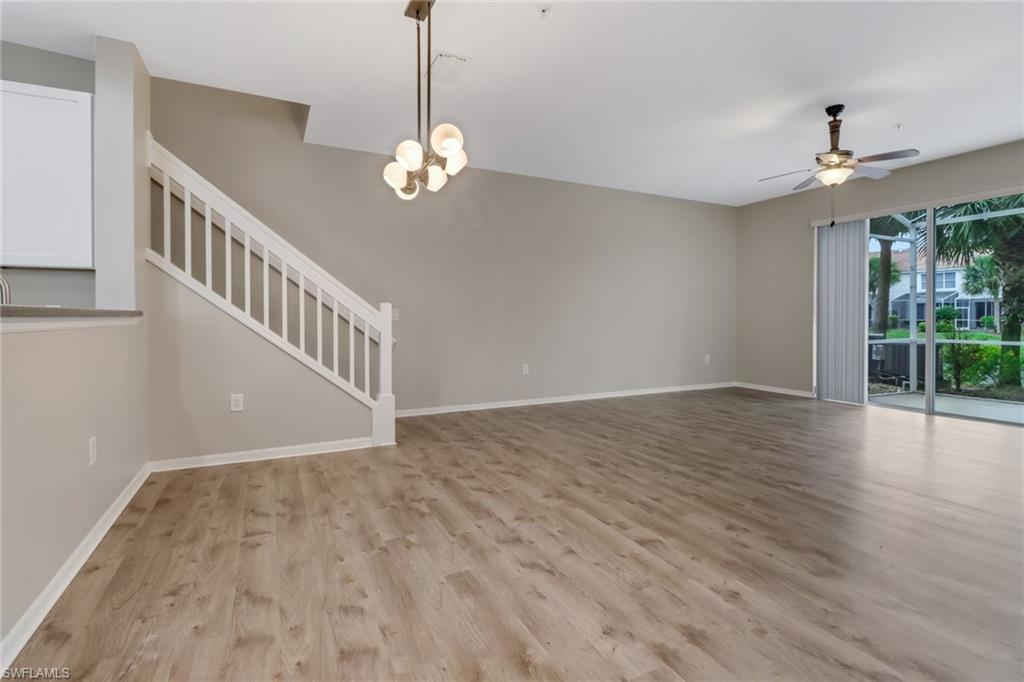 815 Hampton Circle, Unit 143 Naples, FL 34105 - Photo 10 of 30 a view of an empty room with wooden floor and a window