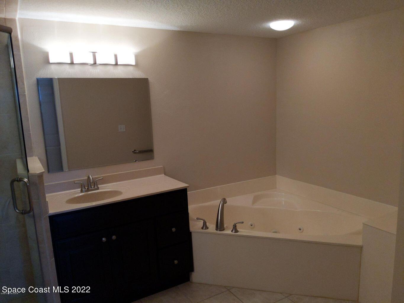 100 Riverside Drive, Unit 702 Cocoa, FL 32922 - Photo 16 of 33 a bathroom with a sink and mirror