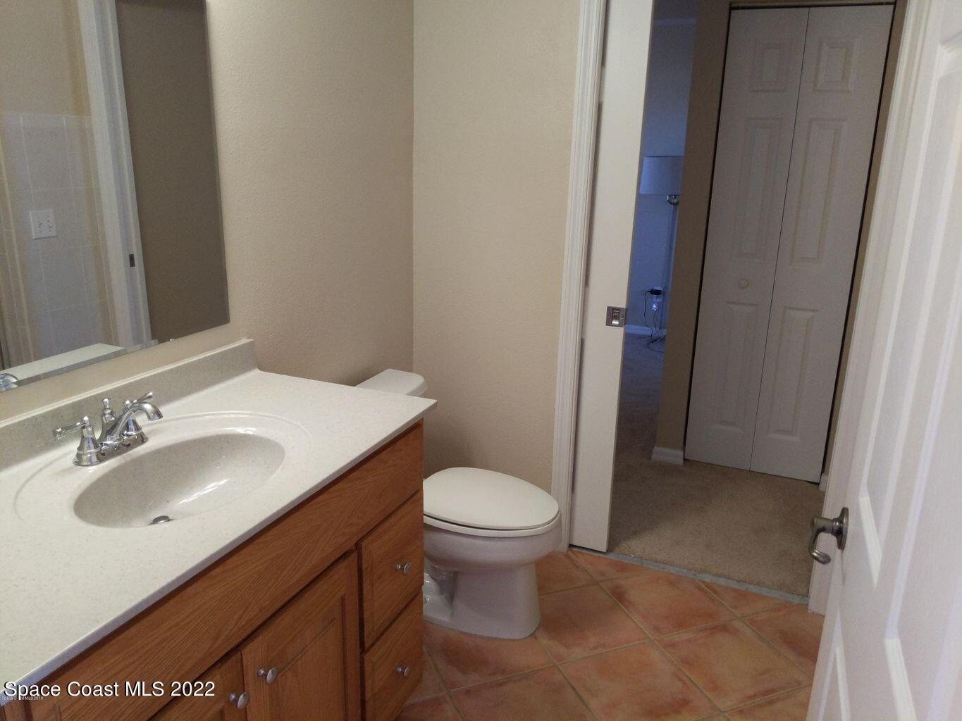 100 Riverside Drive, Unit 702 Cocoa, FL 32922 - Photo 18 of 33 a bathroom with a sink toilet and a mirror
